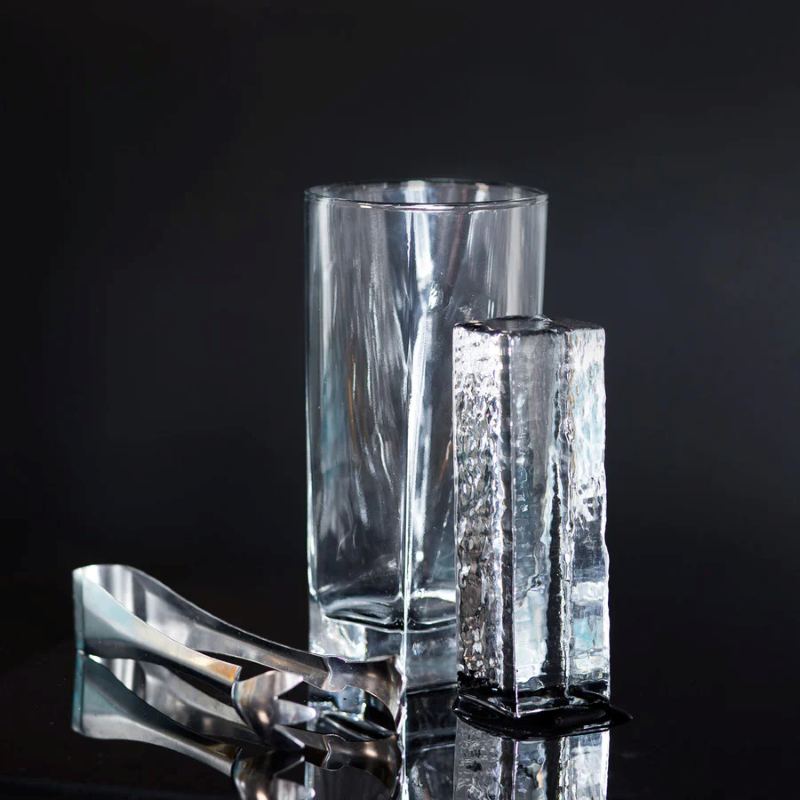 Tall clear ice column 4x4x10cm beside a highball glass, Selangor